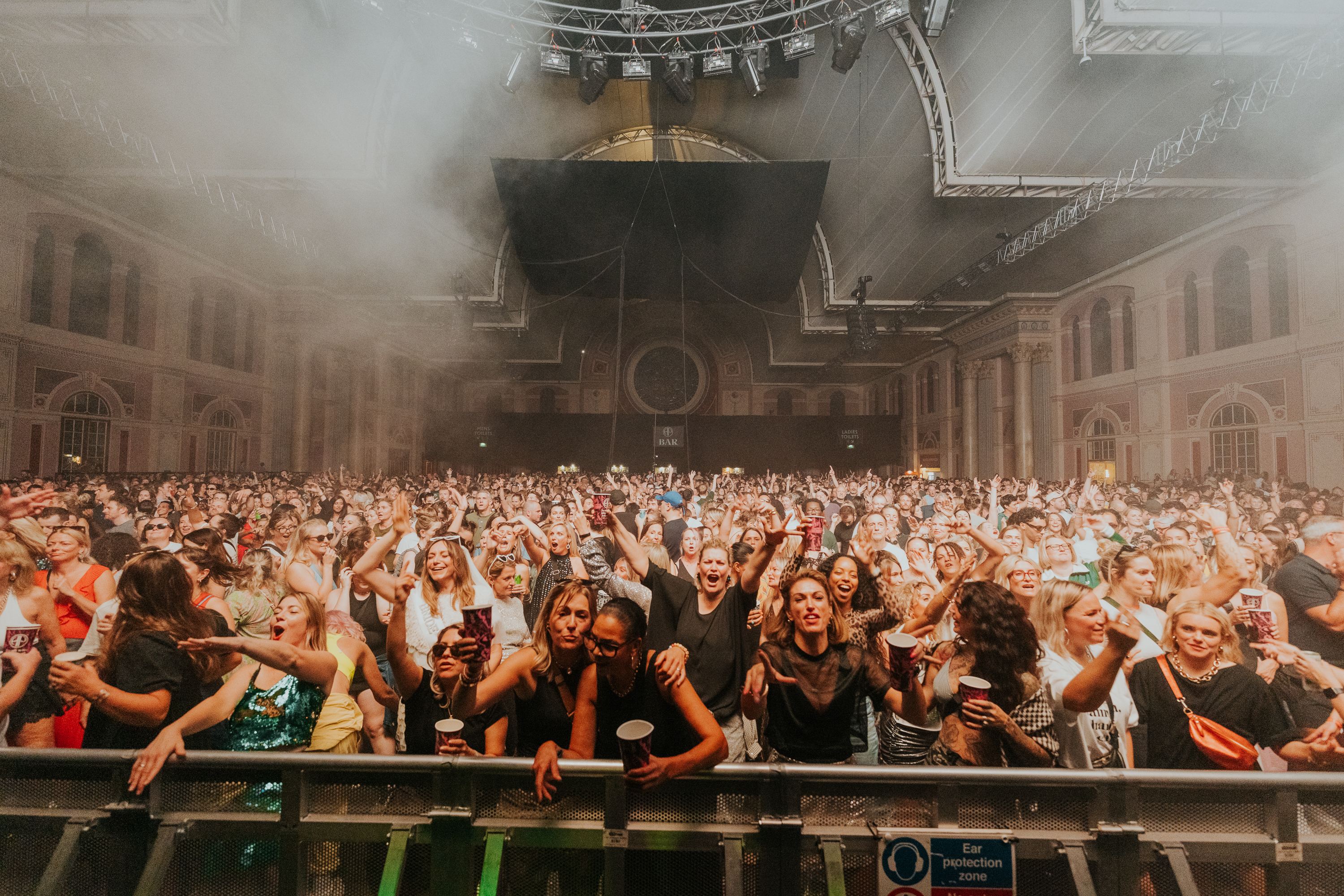 The front rows at Alexandra Palace, arms up and grinning